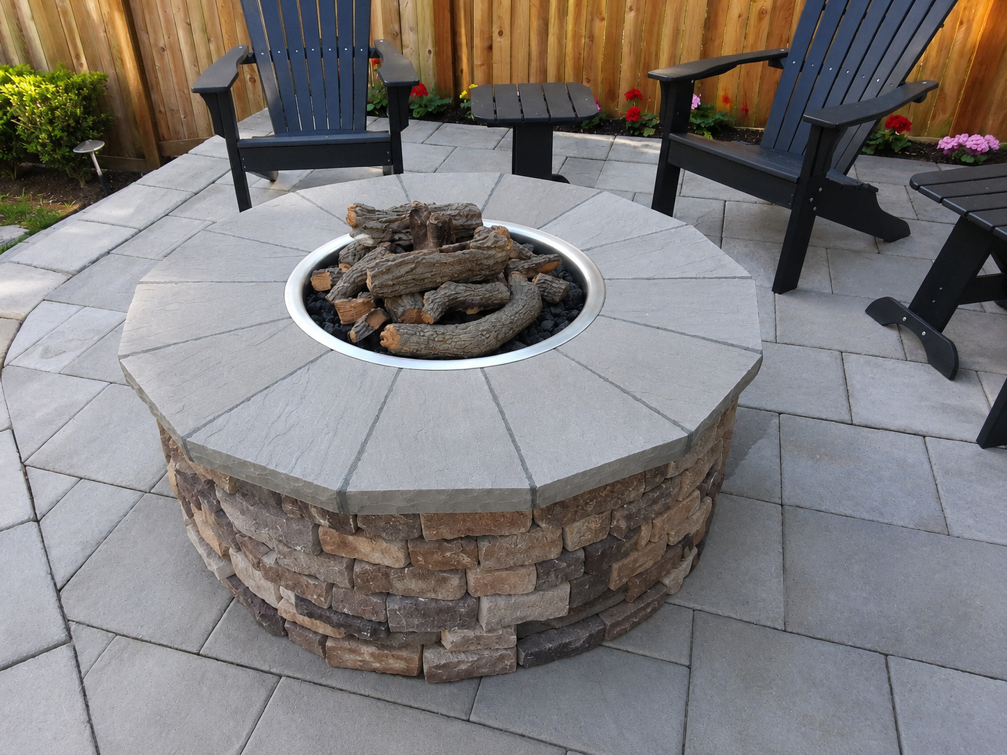 Outdoor stone fire pit and paver patio